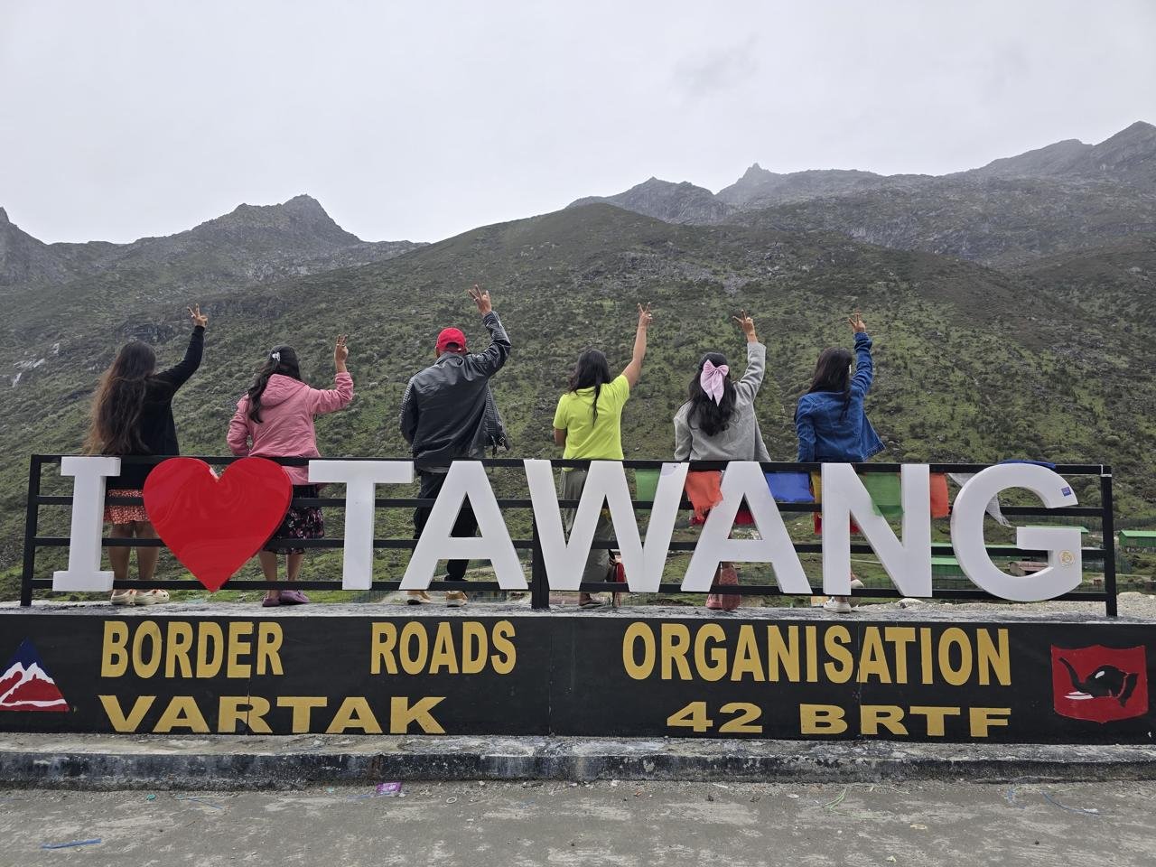 Happy travellers at the I Love Tawang viewpoint